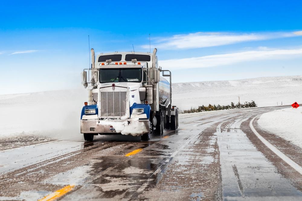 Semi truck driving on winter roads.